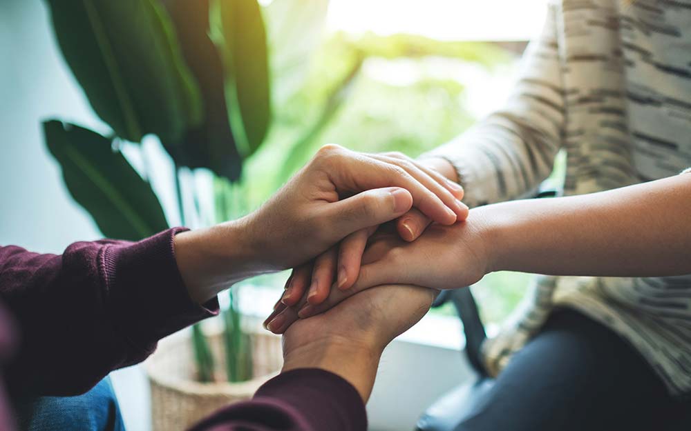 Hands stacked in unity