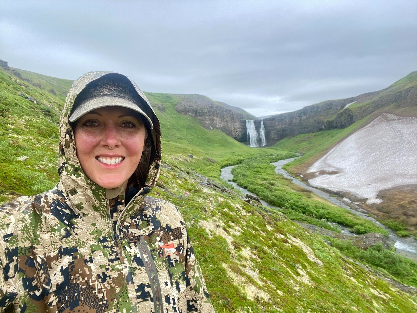 Woman in patterned sweater looking at ocean.