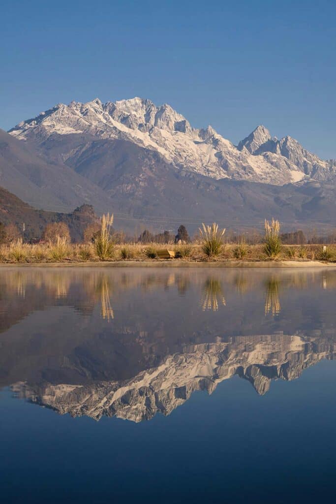 mountain landscape reflected perfectly in a still body of water.
