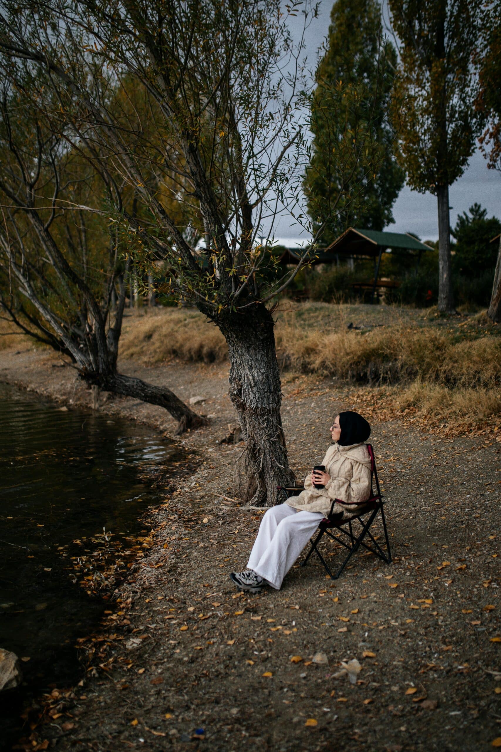 Woman relaxing with a book indoors by a mountain view.